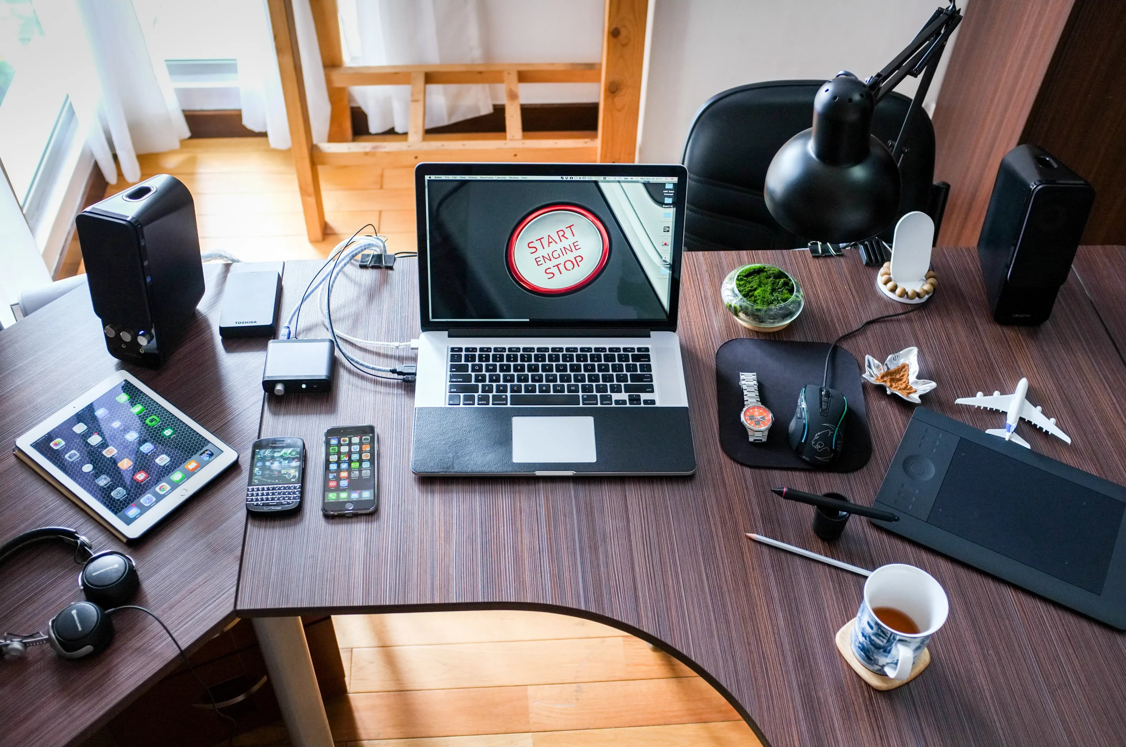 A modern workspace with a laptop and devices, representing the history of Microsoft software