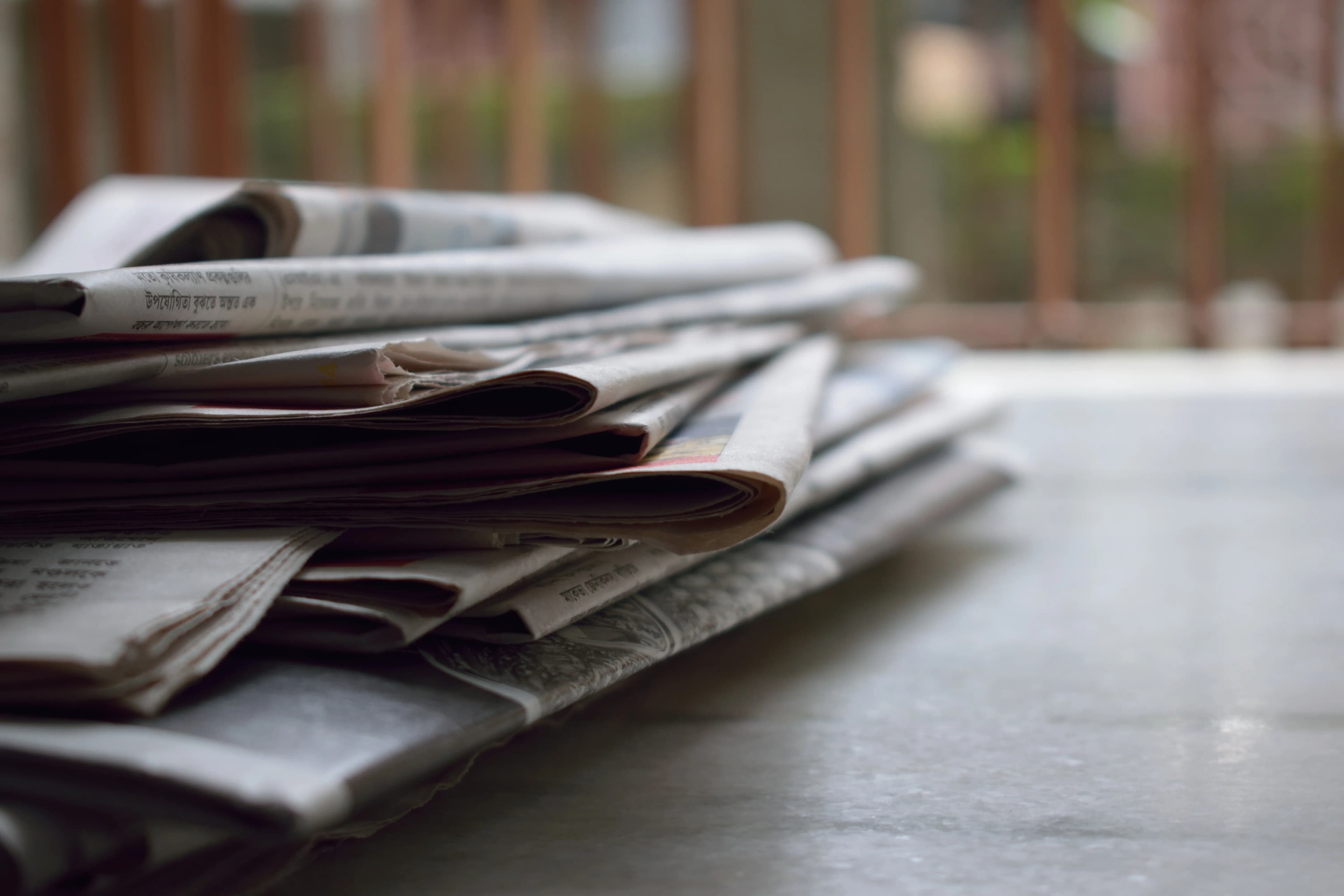 A stack of newspapers, representing the top financial stories moving markets and the world
