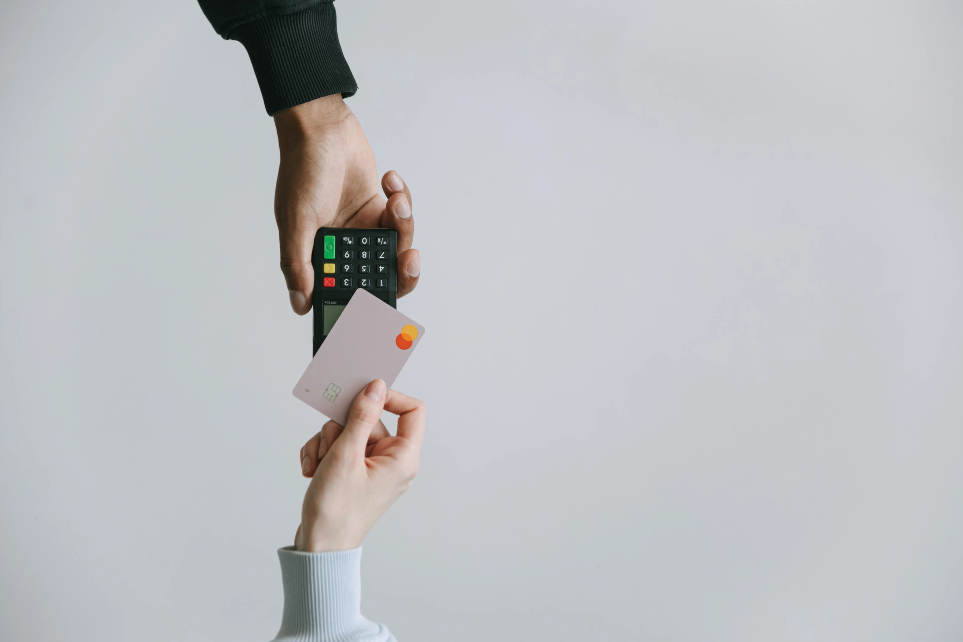A person tapping a card to pay on a card reader, representing Nubank digital banking