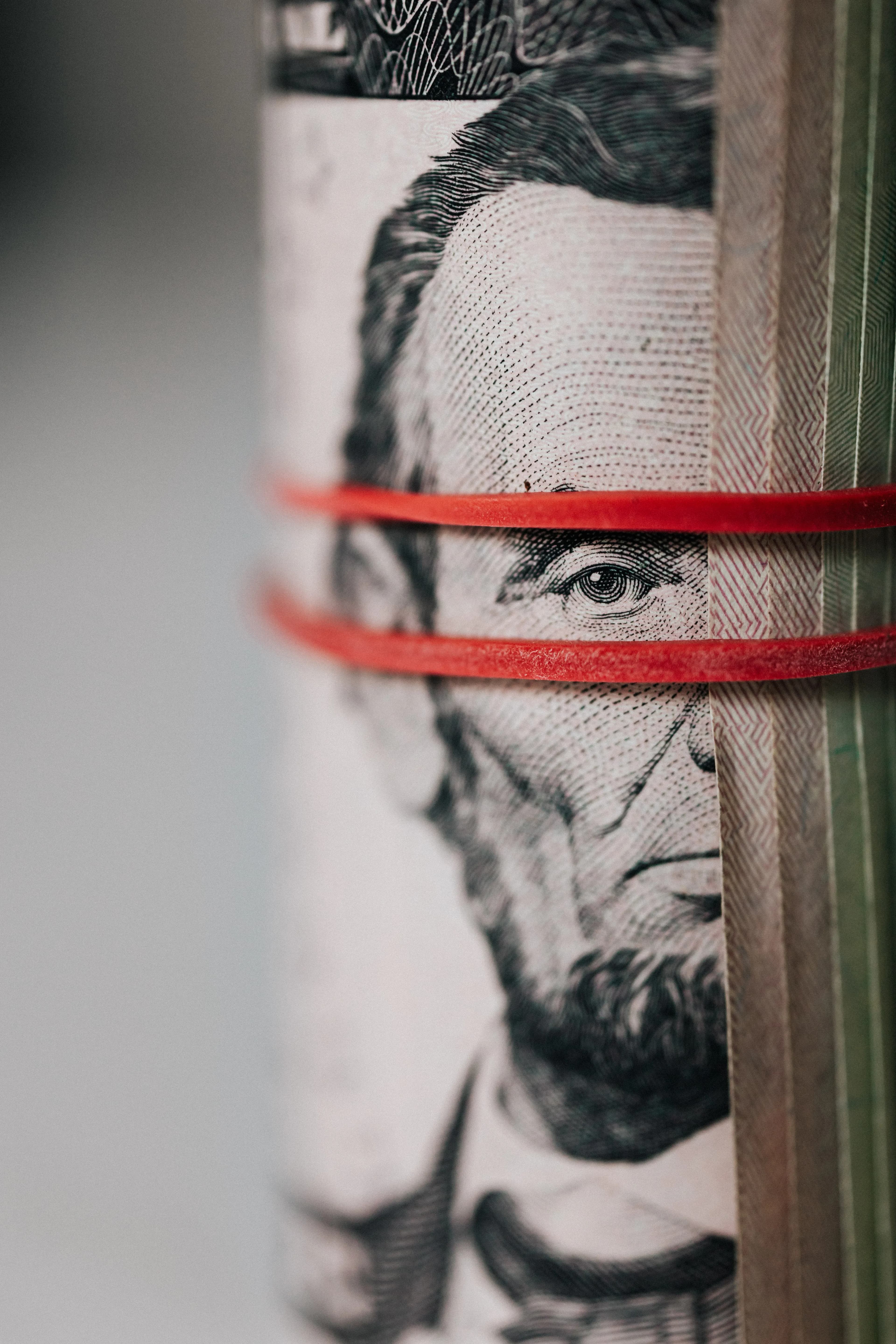 A rolled stack of US dollar bills, representing Dividend Kings and 50 years of rising dividends